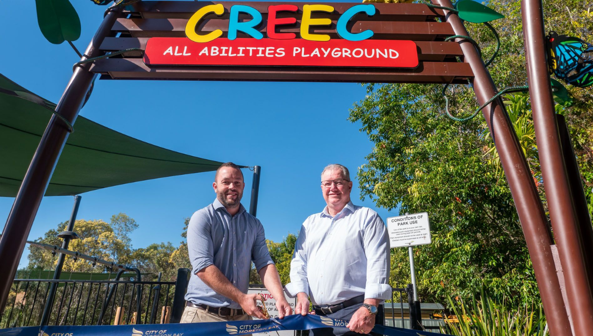 Photo of two men cutitng ribbon for the opening of the Caboolture Region Environmental Education Centre playground