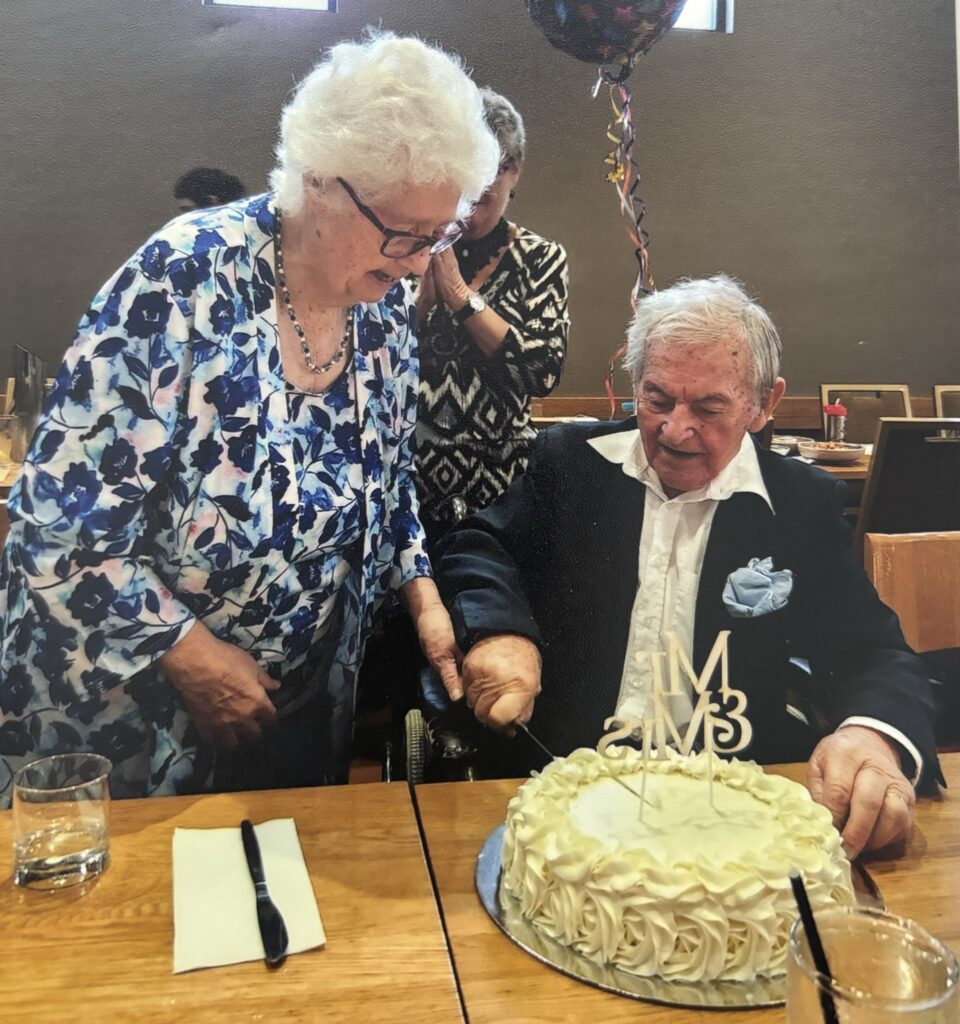 Photo of sweet old couple in love and cutting a cake