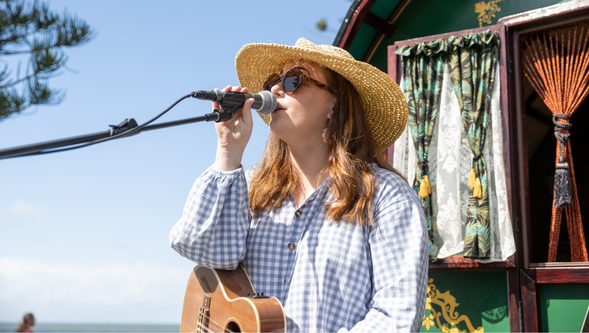 A singer performing on stage for the Beers and Beats Burpengary